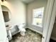 Stylish half bathroom with pedestal sink and natural light at 119 Southern Estates Dr, Sanford, NC 27330