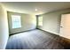 Bright, carpeted bedroom with two windows and light-colored walls at 119 Southern Estates Dr, Sanford, NC 27330