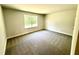 Comfortable bedroom with plush carpeting and window view to the exterior at 119 Southern Estates Dr, Sanford, NC 27330