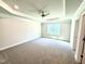 Spacious bedroom with carpet, a tray ceiling, fan, and natural light at 119 Southern Estates Dr, Sanford, NC 27330