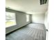 Large, neutral bedroom with two windows and carpeted floor at 119 Southern Estates Dr, Sanford, NC 27330