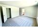 Carpeted bedroom featuring a closet and an open doorway to the ensuite bathroom at 119 Southern Estates Dr, Sanford, NC 27330