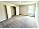 Spacious bedroom featuring a large closet, cozy gray carpet, and natural light at 119 Southern Estates Dr, Sanford, NC 27330