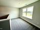 Inviting bedroom featuring plush carpeting and a large window with serene views at 119 Southern Estates Dr, Sanford, NC 27330