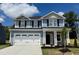 Charming two-story home featuring a two-car garage and stone-accented entryway at 119 Southern Estates Dr, Sanford, NC 27330