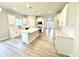 Bright, open kitchen with white cabinets, center island, and modern appliances at 119 Southern Estates Dr, Sanford, NC 27330