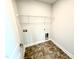 Well-lit laundry room features tile flooring and a convenient overhead shelf at 119 Southern Estates Dr, Sanford, NC 27330