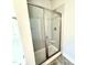 Newly tiled walk-in shower with glass door and built-in seat at 119 Southern Estates Dr, Sanford, NC 27330