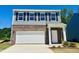 Charming two-story home with brick and siding, featuring a two-car garage and inviting front entrance at 132 N Keatts Winner Ct, Wilson's Mills, NC 27520