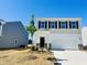 Two-story home with a white garage door, stylish black shutters, and fresh landscaping at 133 N Keatts Winner Ct, Wilson's Mills, NC 27520