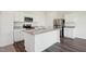 Bright kitchen with an island, stainless steel appliances, and attractive countertops at 133 N Keatts Winner Ct, Wilson's Mills, NC 27520