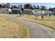 Street view of homes in a neighborhood, showcasing the landscape and curb appeal at 133 N Keatts Winner Ct, Wilson's Mills, NC 27520