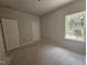 Bedroom with natural light from the window and a closet, ideal for creating a cozy retreat at 143 Mildred Place, Broadway, NC 27505