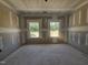Bedroom with drywall, concrete floors, and dual windows at 143 Mildred Place, Broadway, NC 27505
