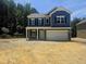 New construction two-story home with navy siding, black shutters and an attached two-car garage on a large lot at 143 Mildred Place, Broadway, NC 27505