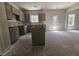 The new kitchen featuring sleek grey cabinets and an island, with ample space for customization at 143 Mildred Place, Broadway, NC 27505