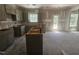 Spacious unfinished kitchen with gray cabinets, an island and natural light at 143 Mildred Place, Broadway, NC 27505