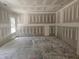 Unfinished living room with gray drywall, concrete floors and a large window at 143 Mildred Place, Broadway, NC 27505