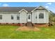Back exterior of the home with a porch and large lawn at 16 Monarch Trl, Selma, NC 27576