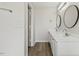 Main bathroom boasts double sinks, round mirrors and wood look flooring at 16 Monarch Trl, Selma, NC 27576