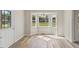 Sunlit dining area featuring a large bay window and wood-look flooring at 16 Monarch Trl, Selma, NC 27576