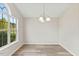 Cozy dining room bathed in sunlight with chandelier lighting at 16 Monarch Trl, Selma, NC 27576