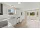 Eat-in kitchen features modern appliances, white cabinets, and a sunlit breakfast nook at 16 Monarch Trl, Selma, NC 27576