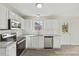 Well-lit kitchen featuring stainless appliances and bright white cabinetry at 16 Monarch Trl, Selma, NC 27576