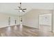 Spacious living room featuring vaulted ceiling, ceiling fan, and outdoor access at 16 Monarch Trl, Selma, NC 27576