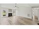 Bright living room with fireplace, ceiling fan and wood-look floors at 16 Monarch Trl, Selma, NC 27576