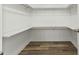 Walk-in closet with laminate flooring and shelving at 16 Monarch Trl, Selma, NC 27576