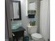 Bathroom featuring a modern glass sink, toilet, and storage at 1613 Beacon Valley Dr, Raleigh, NC 27604