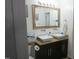 Well-lit bathroom with a double vanity, modern fixtures, and ample counter space at 1613 Beacon Valley Dr, Raleigh, NC 27604
