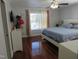 Serene bedroom with hardwood floors, a comfortable bed, and large windows for natural light at 1613 Beacon Valley Dr, Raleigh, NC 27604