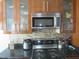 Beautiful kitchen features stainless steel appliances, granite countertops, and stylish tile backsplash at 1613 Beacon Valley Dr, Raleigh, NC 27604