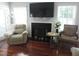 Cozy living room with a fireplace, comfortable seating, and large windows for natural light at 1613 Beacon Valley Dr, Raleigh, NC 27604