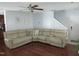 Inviting living room features a comfortable sectional sofa, ceiling fan, and gleaming hardwood floors at 1613 Beacon Valley Dr, Raleigh, NC 27604