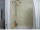 Bathroom shower features travertine-tiled walls and an adjustable shower head at 1613 Beacon Valley Dr, Raleigh, NC 27604