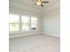 Bright, airy bedroom featuring large windows and a ceiling fan at 1636 Raven Falls Dr, Wendell, NC 27591