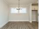 Cozy dining area with chandelier, hard surface floors, and natural light at 1636 Raven Falls Dr, Wendell, NC 27591