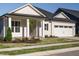 Charming single-story home with a manicured front yard and attached two-car garage at 1636 Raven Falls Dr, Wendell, NC 27591