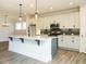 Contemporary kitchen with stone countertops, an island, and stainless steel appliances at 1636 Raven Falls Dr, Wendell, NC 27591