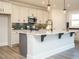 Modern kitchen featuring a marble island, stainless appliances, and dark backsplash at 1636 Raven Falls Dr, Wendell, NC 27591