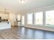 Open-concept space with vinyl floors, neutral colors, and many windows at 1636 Raven Falls Dr, Wendell, NC 27591
