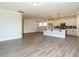 Spacious open-concept featuring modern kitchen and luxury vinyl plank flooring at 1636 Raven Falls Dr, Wendell, NC 27591