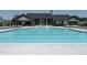 Beautiful pool and clubhouse with fountains, lounge chairs, and outdoor seating areas at 1636 Raven Falls Dr, Wendell, NC 27591