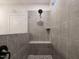 Contemporary shower stall with gray tile and pebble flooring at 1636 Raven Falls Dr, Wendell, NC 27591