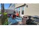 Cozy back patio with comfortable seating, dining table, grill and outdoor decor at 1643 Wimberly Rd, Apex, NC 27523