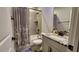 Well-lit bathroom with a combination shower and tub, featuring granite countertops and tiled walls at 1643 Wimberly Rd, Apex, NC 27523