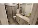 Modern bathroom with granite countertops, glass-enclosed shower, and neutral tile flooring at 1643 Wimberly Rd, Apex, NC 27523